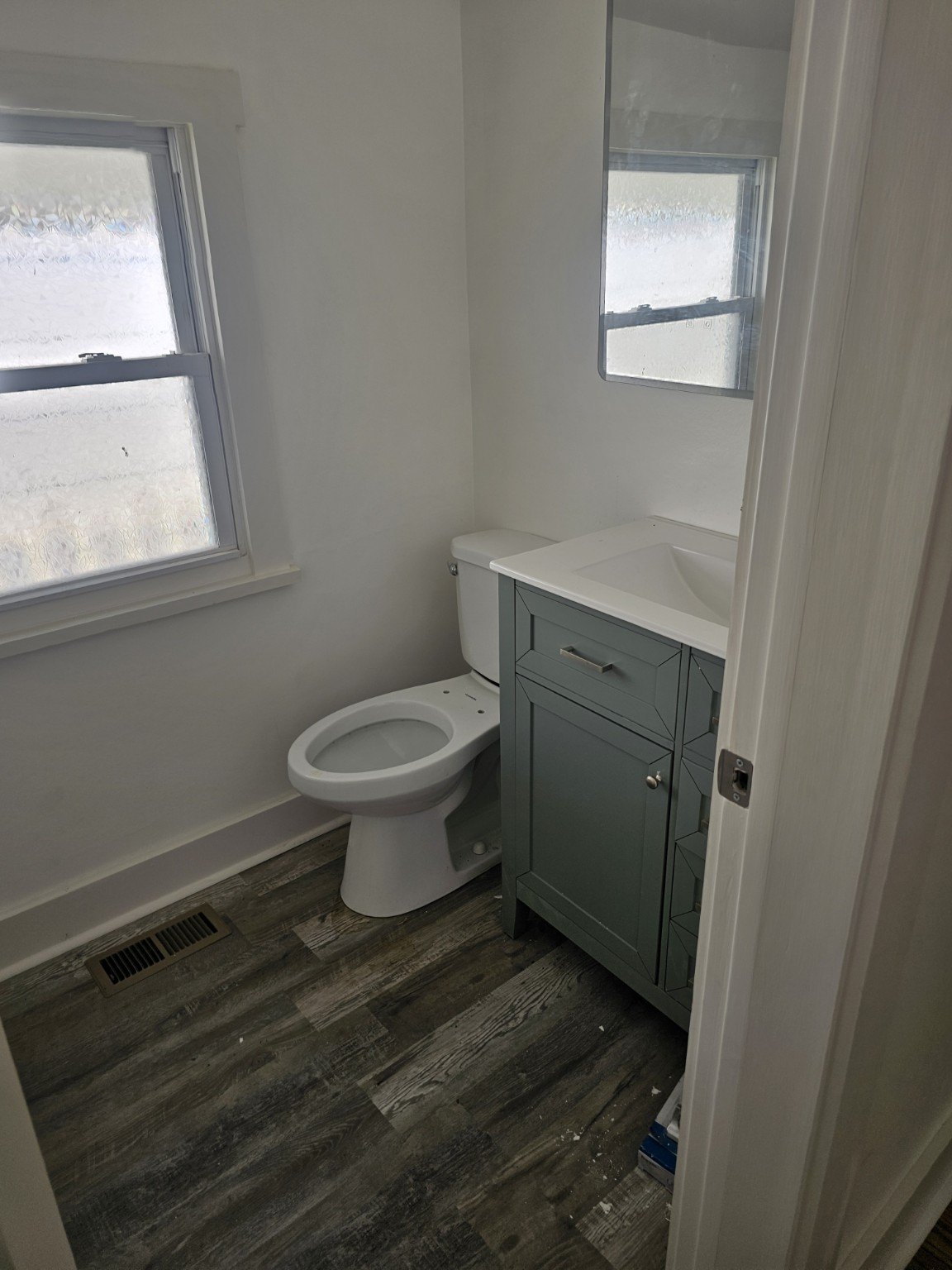 Renovated bathroom with vanity and privacy window