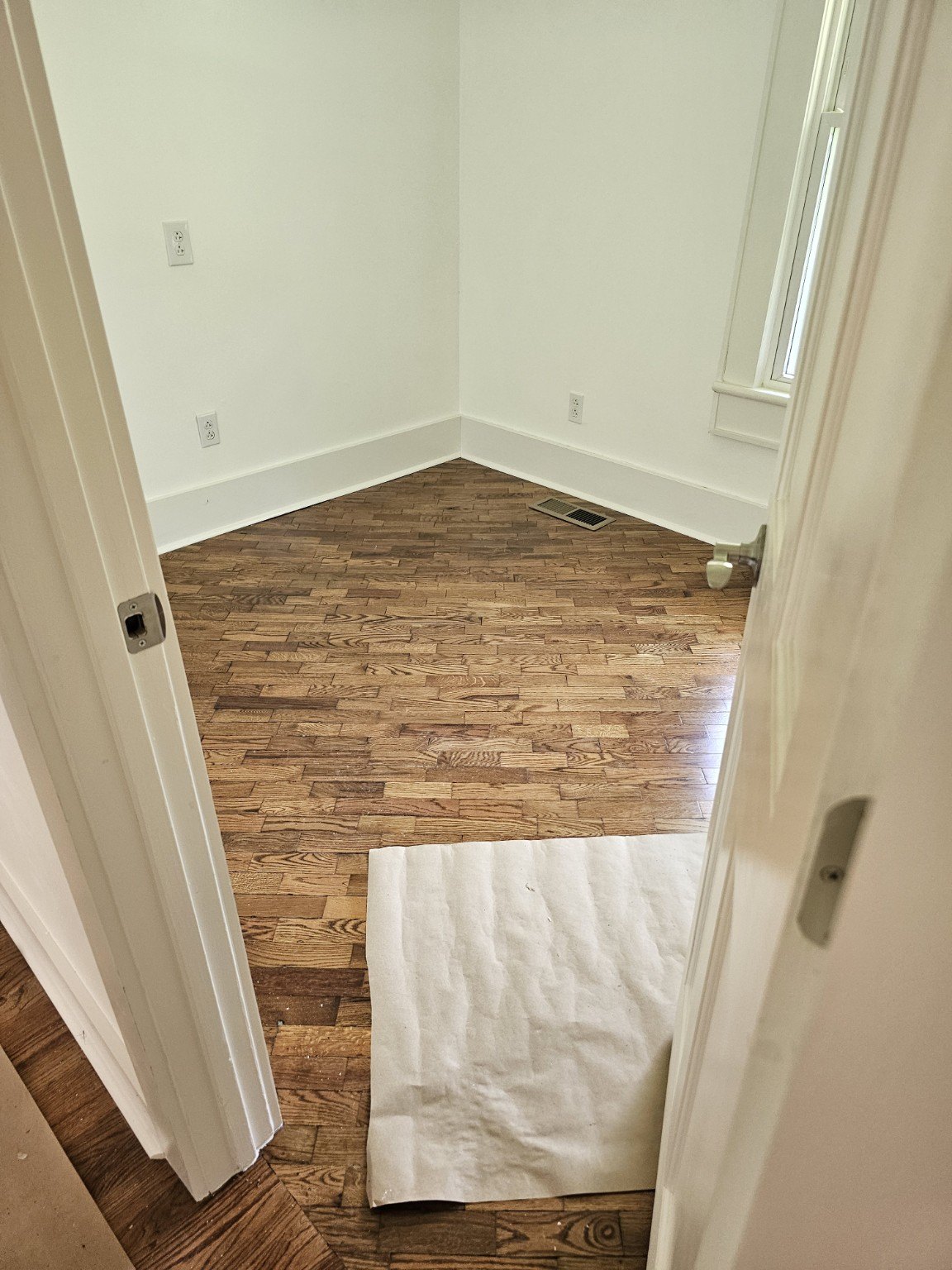 Bedroom with refinished hardwood floor