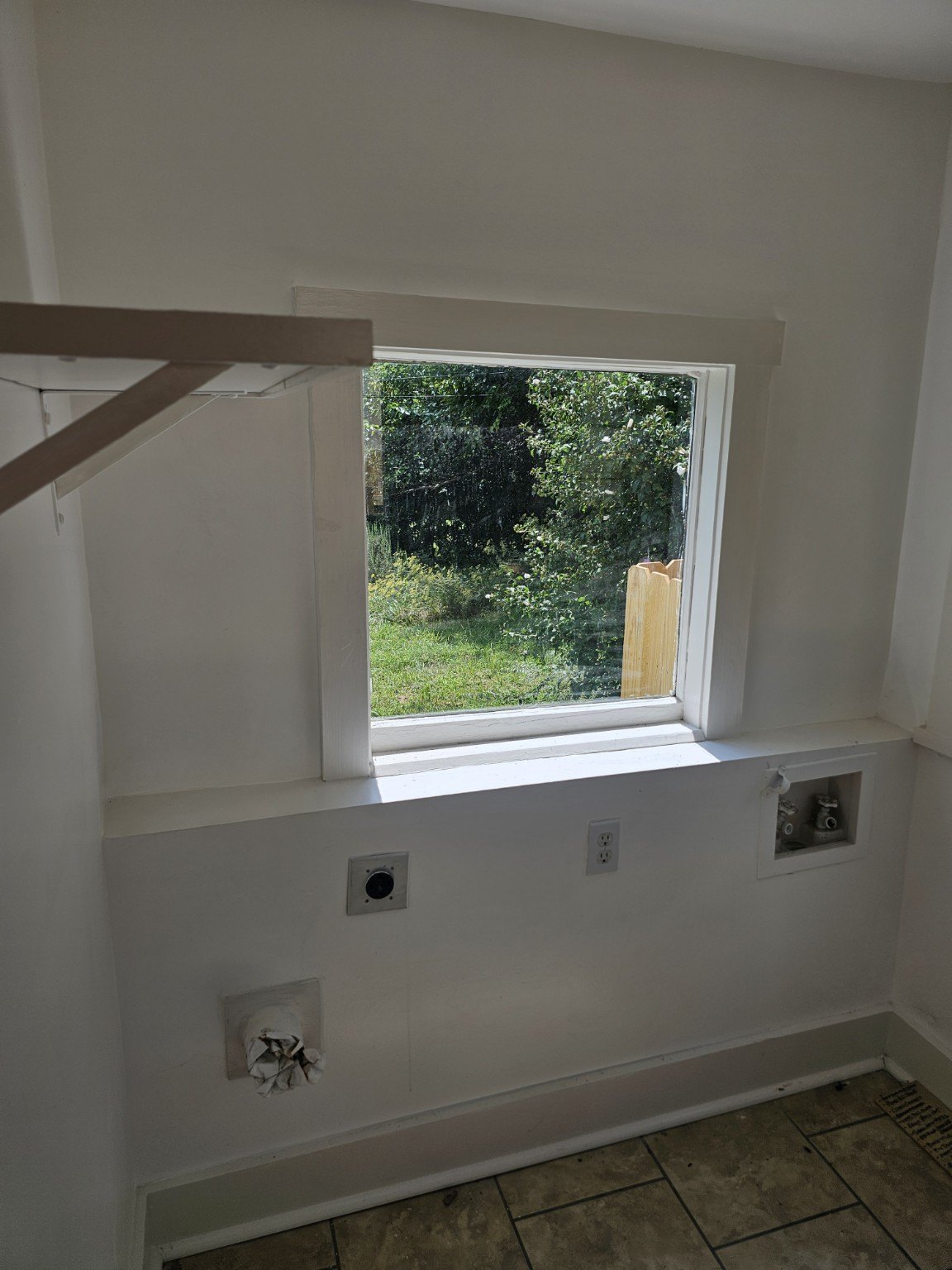 Laundry and mudroom area with exterior door and window